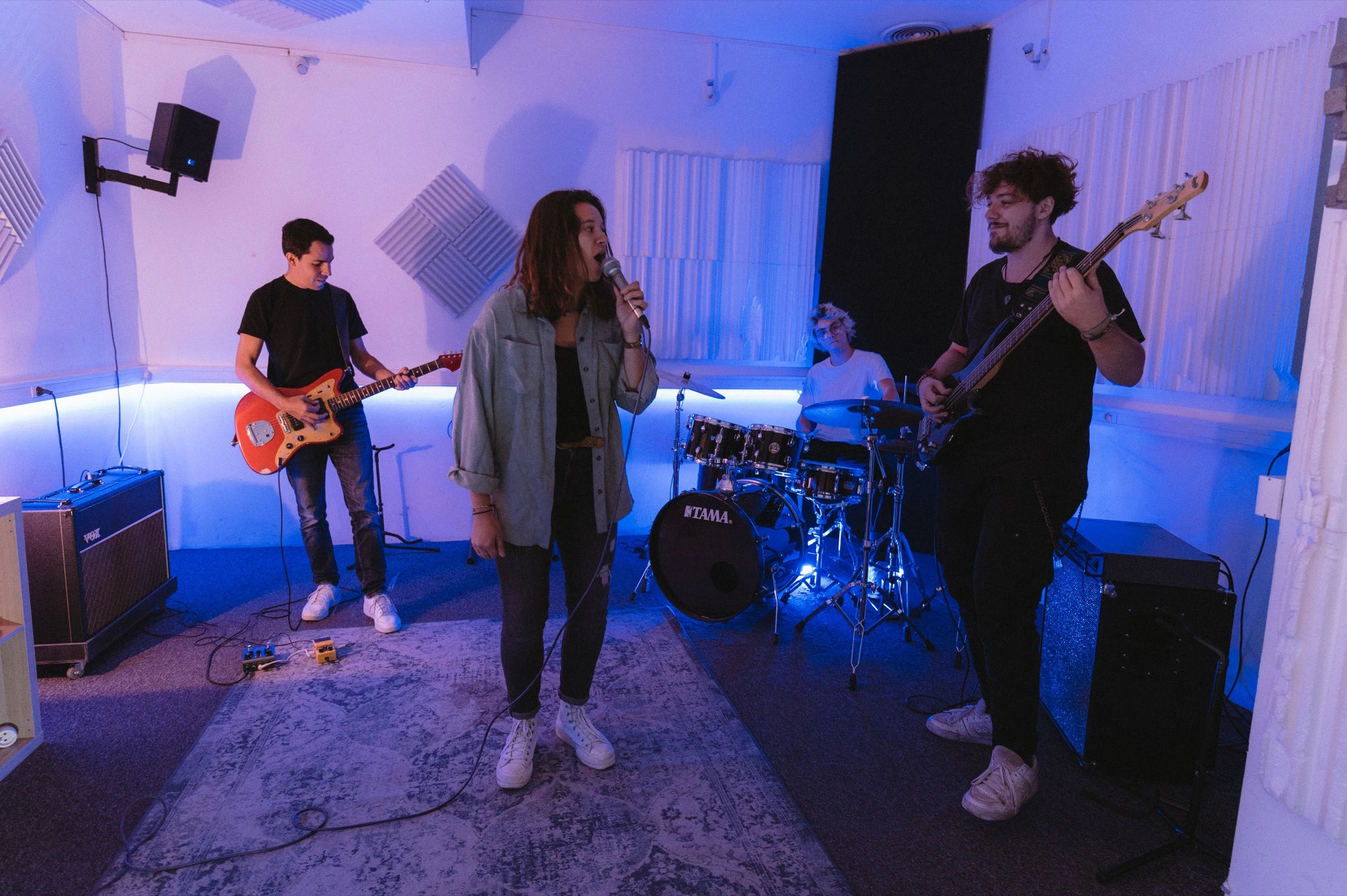 Photo of artists producing and playing in a rehearsal and beatmaking studio